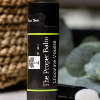Lip balm labeled "The Proper Balm" chocolate mousse.