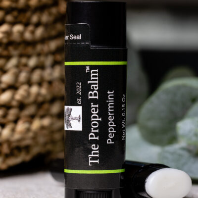 Peppermint lip balm tube on a surface.