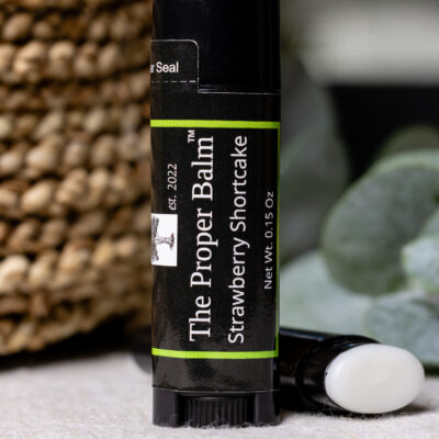 Strawberry shortcake lip balm in black tube.