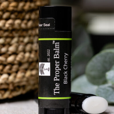 Lip balm labeled "The Proper Balm" Black Cherry.
