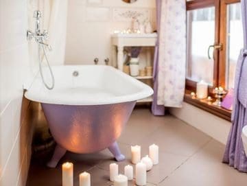 A bathroom with candles and a tub in it