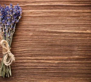 A wooden table with lavender tied to it.