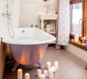 Candlelit clawfoot bathtub with lavender accents